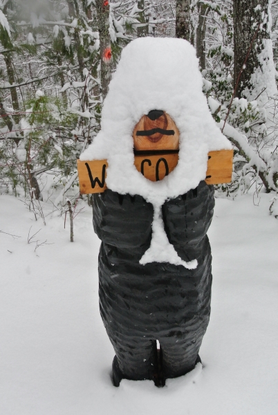 Chainsaw Bear Welcome Sign in the Snow